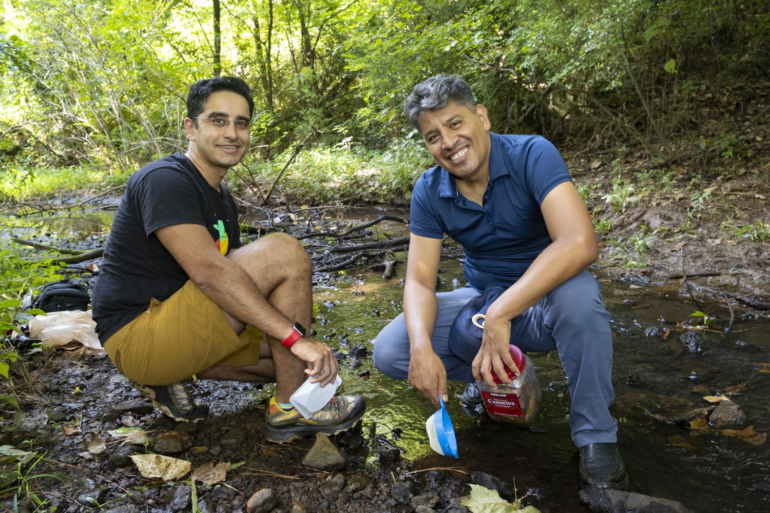 Víctor Ortega-Jiménez and a fellow researcher exploring a creek to observe springtails.