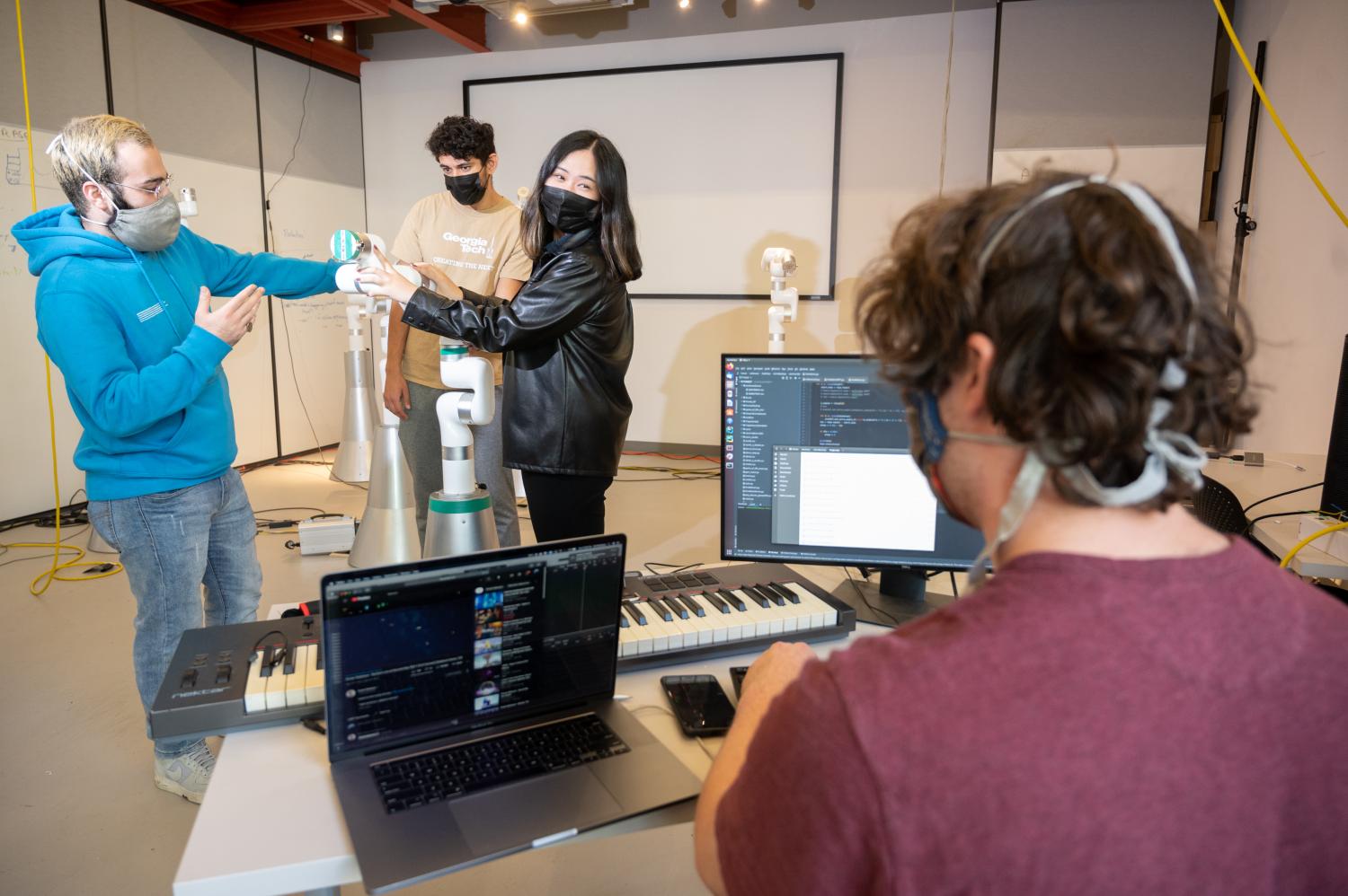 Georgia Tech Music Technology graduate student Amit Rogel (foreground, right) consults with other FOREST project researchers (L to R) Mohammad Jafari,  Michael Verma and Rose Sun.  (Photo credit: Allison Carter, Georgia Tech)