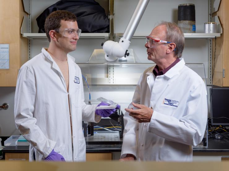 <p>Graduate student Brian Schmatz (l.) and John Reynolds, a professor in the School of Chemistry and Biochemistry and the School of Material Science and Engineering, in Reynolds's lab at Georgia Tech. Credit: Georgia Tech / Rob Felt</p>