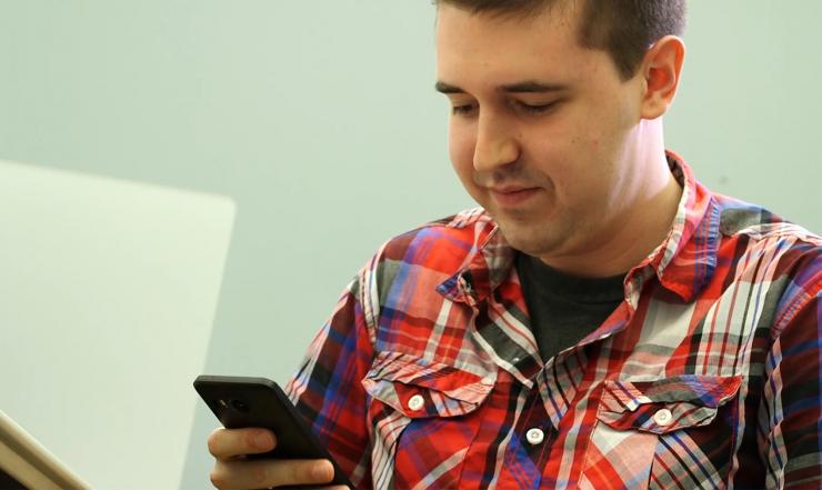 <p>Carter Yagemann, a graduate research assistant in Georgia Tech’s School of Computer Science, checks permissions on an Android phone. Cybersecurity researchers have identified a new vulnerability affecting Android mobile devices that results not from a traditional bug, but from the malicious combination of two legitimate permissions that power desirable and commonly-used features in popular apps. (Credit: Maxwell Guberman, Georgia Tech)</p>