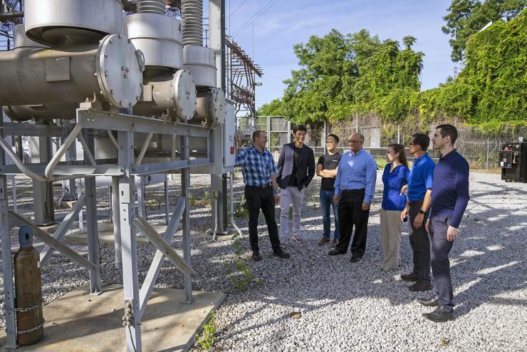 TESLA team examining a high-voltage circuit breaker