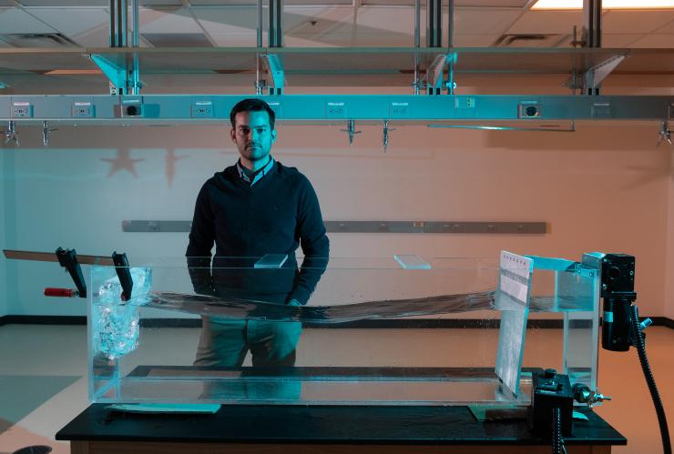 <p>The study's principal investigator Alex Robel in his lab at Georgia Tech standing at an ice-melting tank. Credit: Georgia Tech / Allison Carter</p>