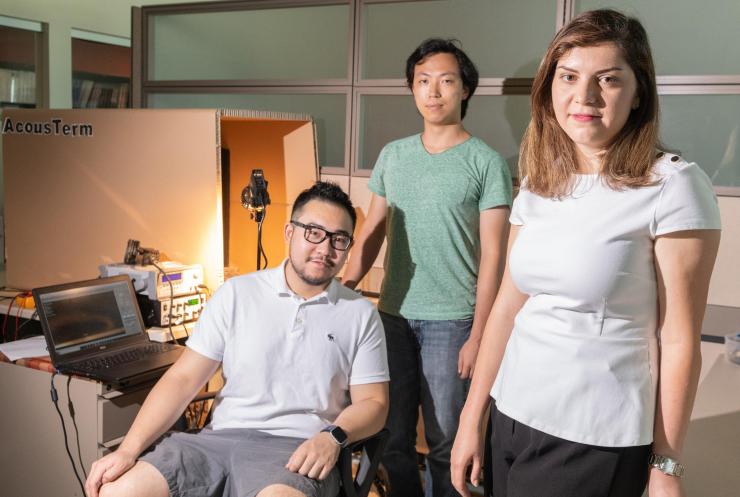 <p>Georgia Tech researchers Azadeh Ansari, DeaGyu Kim and Zhijian (Chris) Hao are shown in their laboratory. The chamber in the background is used to test the micro-bristle-bot. (Photo: Allison Carter, Georgia Tech)</p>