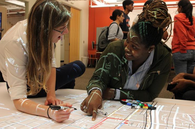 <p>Visitors use the Map Room in Assistant Professor Yanni Loukissas' Local Data Design Lab in the Technology Square Research Building. (Joshua Preston/GVU)</p>