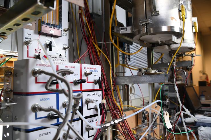 A labyrinth of tubes delivers fuel, oxygen and other gases into experimental fuel cells (rear, top) in Regents' Professor Meilin Liu's lab. Liu is developing nanomaterial catalysts that turbocharge fuel cell performance in hopes of empowering the development of multiple zero-emissions renewable energy sources. Credit: Georgia Tech / Christopher Moore