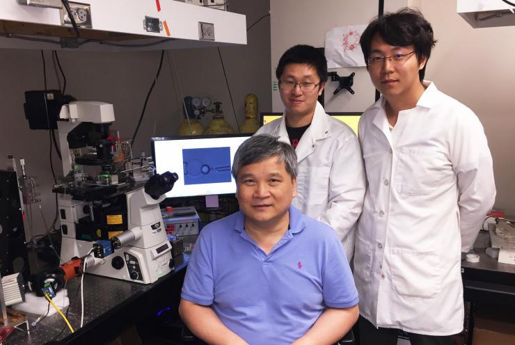 Researchers with force measurement tool