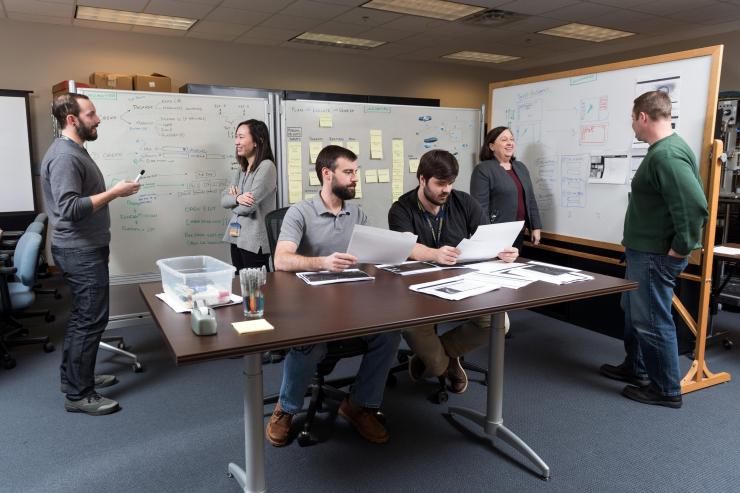 <p>GTRI researchers translate mission planning requirements into interface designs. Shown are Research Scientist Andrew Baranak, Georgia Tech Graduate Student Rachel Chen, Research Engineer Robert Kempf, Research Scientist Chandler Price, Research Scientist Andrew Baranak, Senior Research Scientist Marcia Crosland and Senior Research Scientist C.J. Hutto. (Credit: Rob Felt, Georgia Tech)</p>