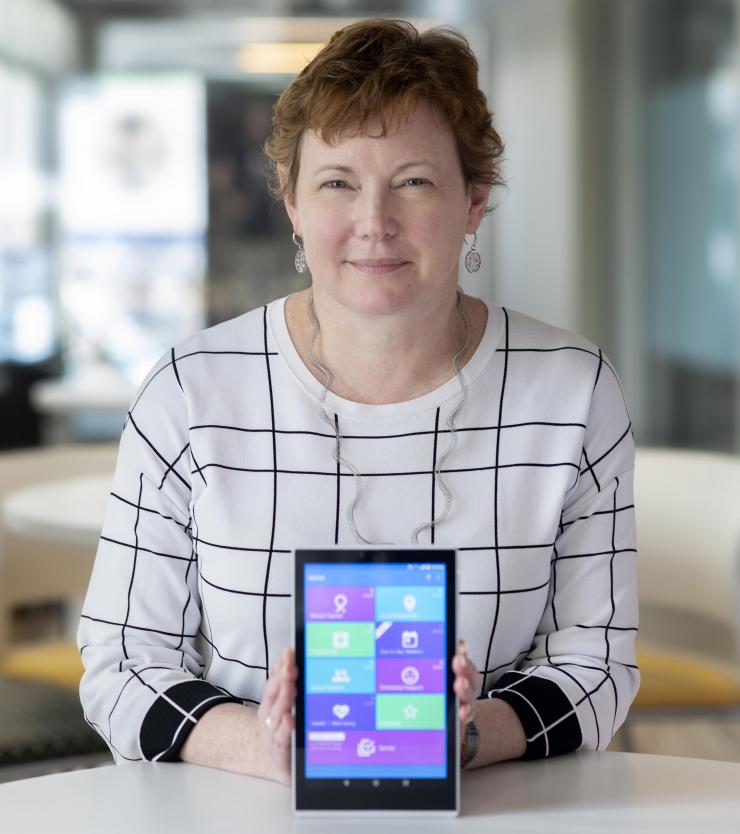 <p>Elizabeth Mynatt, executive director of the Georgia Tech Institute for People and Technology and a professor in the Georgia Tech School of Interactive Computing, holds a tablet computer running the MyPath application. (Photo: Christopher Moore, Georgia Tech)</p>