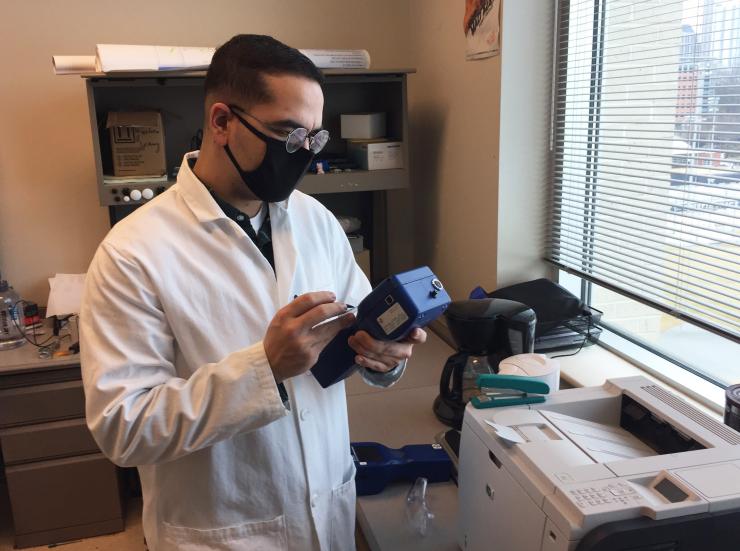 Georgia Tech researcher Jean C. Rivera-Rios obtains air samples from an office on the campus of the Georgia Institute of Technology. (Credit: John Toon, Georgia Tech)