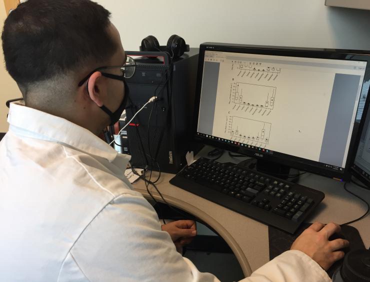 Georgia Tech researcher Jean C. Rivera-Rios examines data on air sampling done in a variety of settings, from aircraft cabins and offices to restaurants, stores and homes. (Credit: John Toon, Georgia Tech)