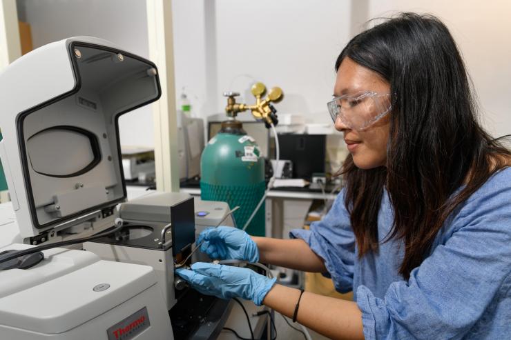 <p>Georgia Tech graduate research assistant Yu-Hsuan Liu places a sample of titanium dioxide into test equipment in the laboratory of assistant professor Marta Hatzell. (Credit: Rob Felt, Georgia Tech)</p>