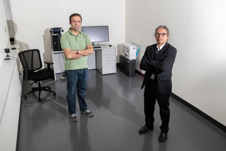 <p>Anand Chandrasekaran, a postdoctoral researcher, and Rampi Ramprasad, a professor in the School of Materials Science and Engineering, stand in a room with a high-powered computer dedicated to machine learning. (Credit: Allison Carter)</p>