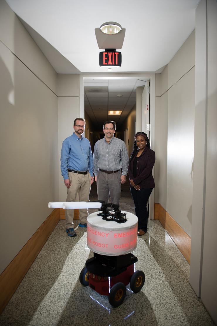 <p> Georgia Tech researchers shown with their “Rescue Robot.” (L-R) GTRI Research Engineer Paul Robinette, GTRI Senior Research Engineer Alan Wagner and School of Electrical and Computer Engineering Professor Ayanna Howard. (Credit: Rob Felt, Georgia Tech)</p>