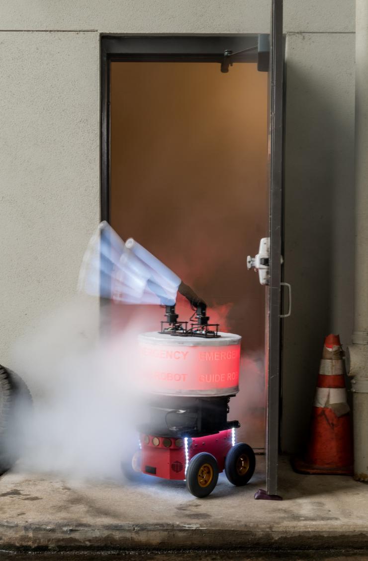 <p>A long camera exposure shows how the arms of the “Rescue Robot” give directions to building occupants in case of fire or other emergency. (Credit: Rob Felt, Georgia Tech)</p>