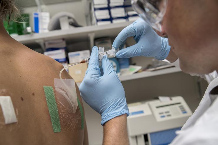 <p>A research scientist withdraws sweat from a pouch on the back of a volunteer. Sweat is analyzed for electrolyte concentration among other biochemicals in Mindy Millard-Stafford's exercise physiology lab in Georgia Tech's School of Biological Sciences. This photo is not connected with any particular study. Credit: Georgia Tech / Christopher Moore</p>