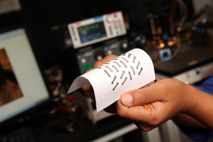 <p>Akanksha Menon, a Ph.D. student in the Woodruff School of Mechanical Engineering at the Georgia Institute of Technology, shows an example of a circuitry pattern based on the Hilbert curve and printed on paper for thermoelectric conversion. (Credit: Candler Hobbs, Georgia Tech).</p>