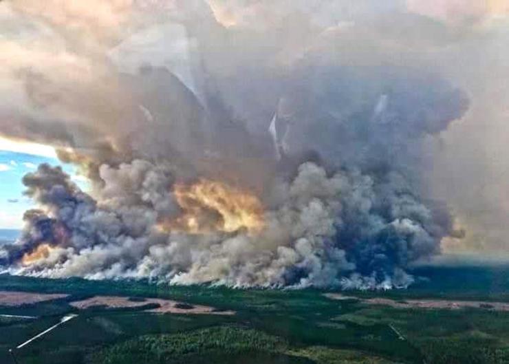 <p>Smoke rises from the wildfire burning across 150,000 acres of the Okefenokee Swamp in Georgia and Florida. (Credit: USFWS)</p>