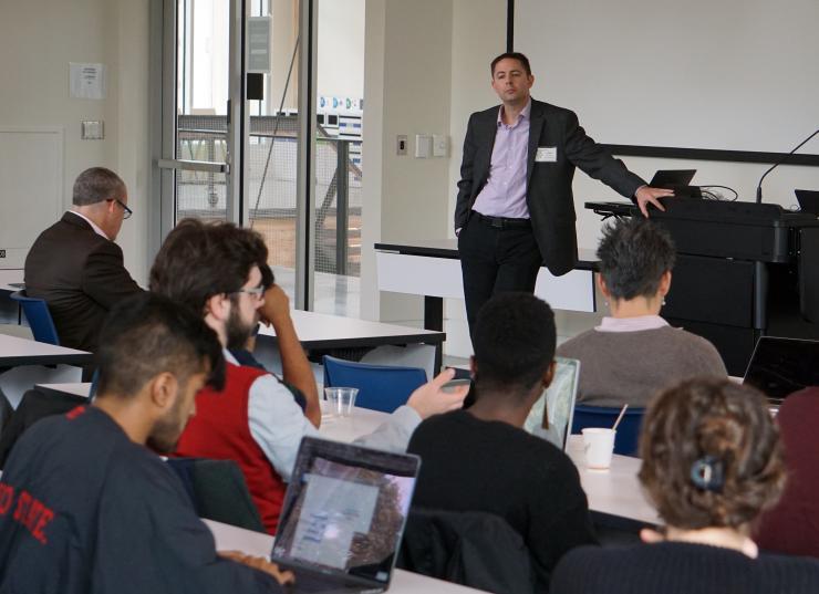 <p>Chris Rozell addresses the room during the Intelligent Interactions with the Brain (I2B) Workshop.</p>