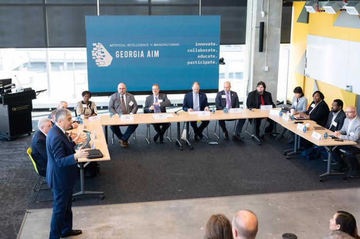 <p>Georgia Tech Executive Vice President for Research Chaouki T. Abdallah (standing) addresses representatives of the Economic Development Administration and members of the Georgia Artificial Intelligence in Manufacturing (Georgia AIM) coalition Nov. 14, 2022. (PHOTO: Joya Chapman)</p>