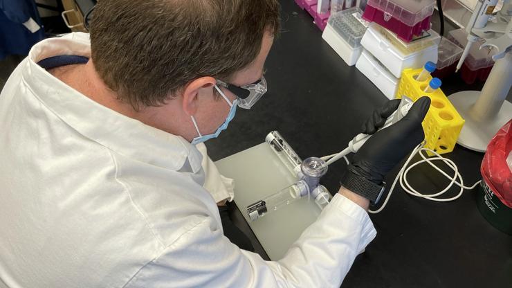 <p>Researcher Daryll Vanover works with the nebulizer he adapted to test a new mRNA-based treatment for flu and Covid-19. The team used mRNA technology to code for a protein called Cas13a that destroys parts of the RNA genetic code that viruses use to replicate in cells in the lungs. It was developed by researchers in Philip Santangelo’s lab in the Wallace H. Coulter Department of Biomedical Engineering. (Photo Courtesy: Daryll Vanover)</p>