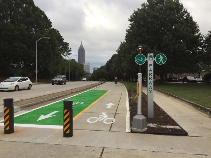 <p>A cyclist rides south on the PATH Parkway near the intersection of Means Street</p>