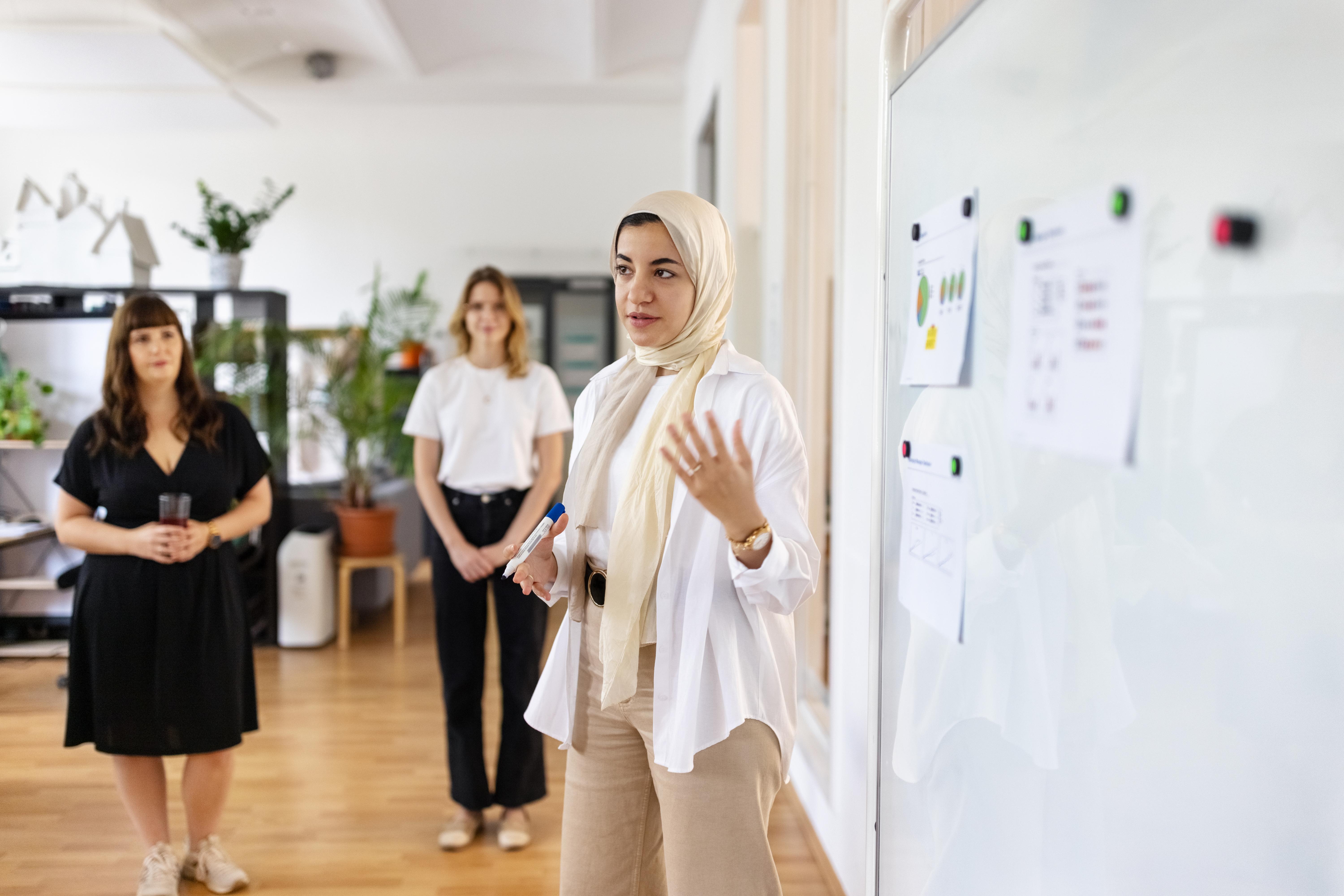 Woman gives presentation to colleagues