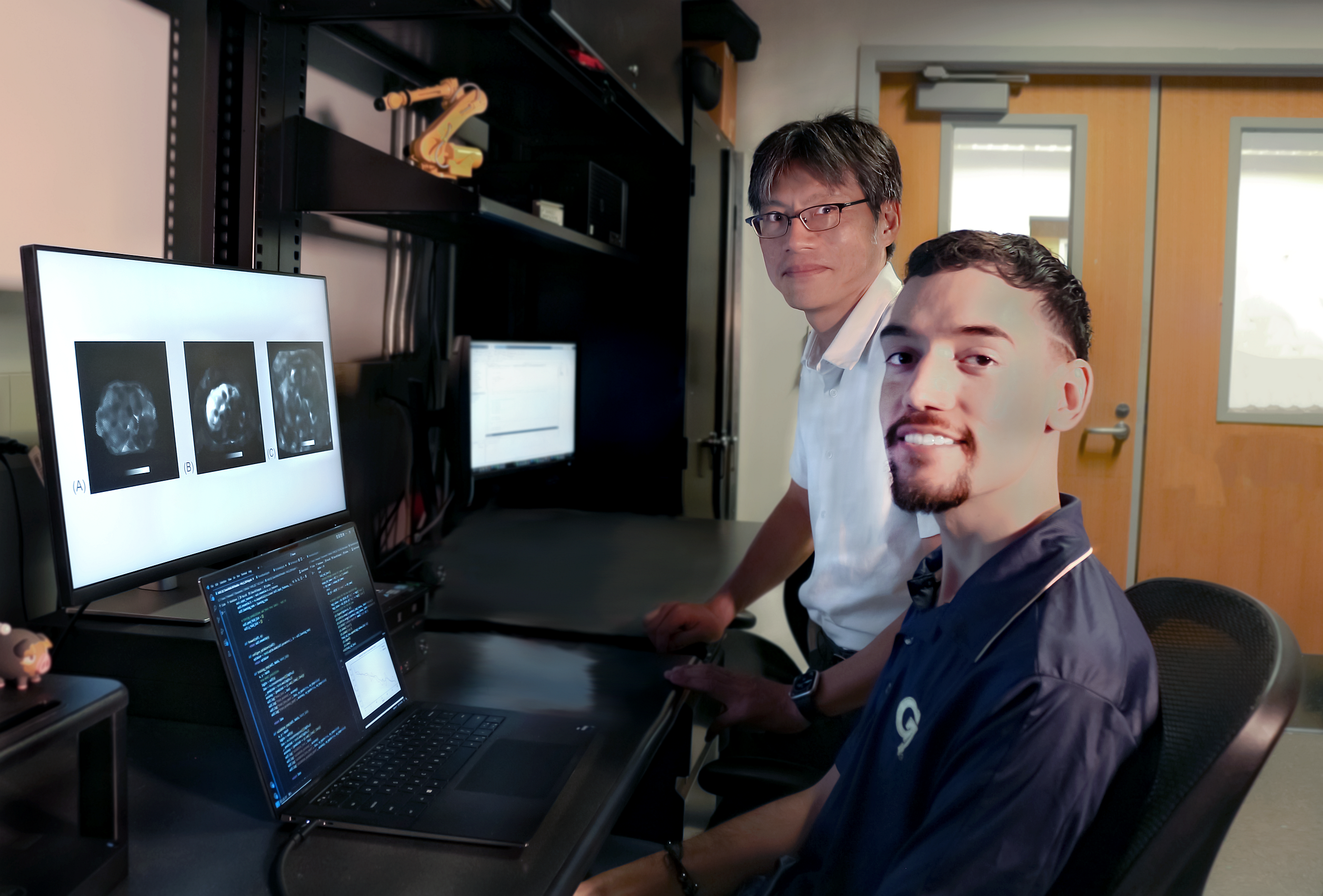 Professor Jun Ueda in the George W. Woodruff School of Mechanical Engineering and robotics Ph.D. student Heriberto Nieves.