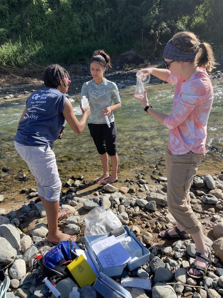 EAS graduate students sample water during a November trip to Puerto Rico: (From L to R) Sharissa Thompson, Tatiana Gibson, Dru Ann Harris. (Photo Frances Rivera-Hernández.)