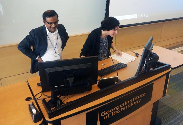 <p>Krish Roy and Johnna Temenoff, director and deputy director of CMaT, respectively, prepare the room for the next session.</p>