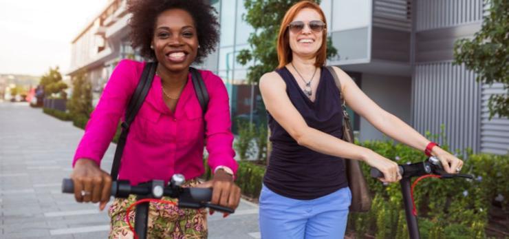 Two women on scooters