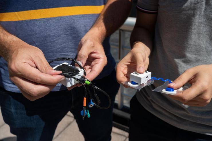 <p>Close-up view of Omer Inan and Samer Mabrouk holding prototypes of their new sensor</p>