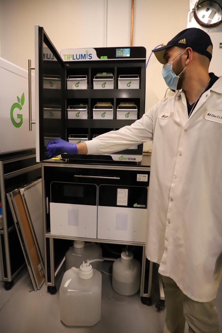 TipCycle project manager Adam Fallah demonstrates how Grenova's pipette tip washing system operates.