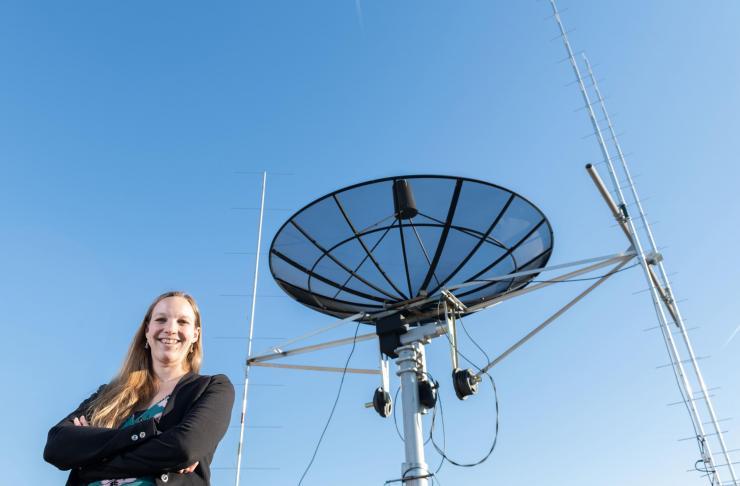 <p>Georgia Tech assistant professor Mariel Borowitz is shown with satellite communications equipment. Dramatic growth in the generation and collection of data will change the way federal agencies make data available. (Photo: Allison Carter, Georgia Tech)</p>