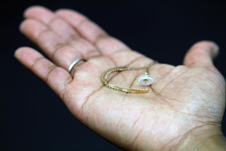 <p>An earring is shown paired with a transdermal patch backing. The white ring is the patch containing the contraceptive hormone. (Credit: Mark Prausnitz, Georgia Tech)</p>