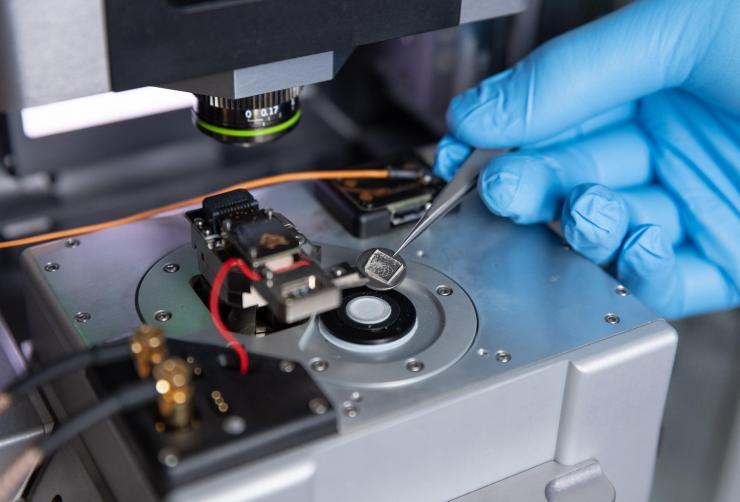 <p>A single crystal sample is placed onto the measurement stage of the modified atomic force microscope (i.e. piezoresponse force microscope). (Photo: Rob Felt, Georgia Tech)</p>