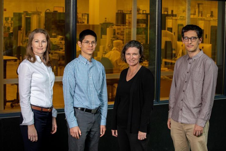 <p>GTRI researchers Brooke Beckert, Nicholas Guise, Alexa Harter and Adam Meier are shown outside the cleanroom of the Institute for Electronics and Nanotechnology at the Georgia Institute of Technology. Device fabrication for the DNA data storage project will be done in the facility behind them. (Credit: Branden Camp, Georgia Tech)</p>