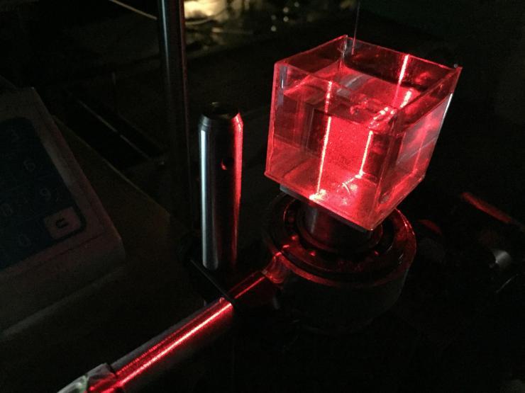 <p>A sheet laser illuminates a toroidal droplet formed in silicone oil to help researchers image the flow field movement inside the droplet. (Credit: John Toon, Georgia Tech)</p>