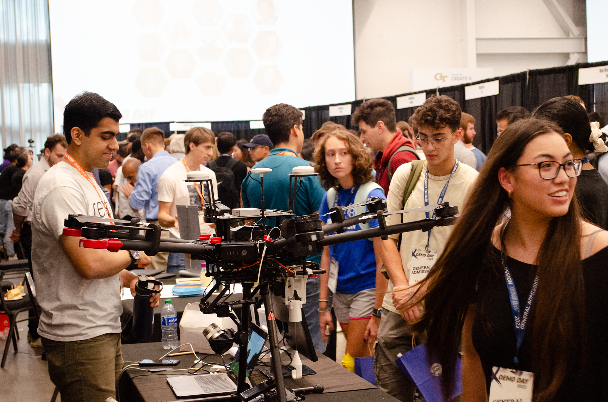 At booths, Georgia Tech founders showcase their new products to a crowded exhibition hall with people from the Georgia Tech community, as well as the public and business community.