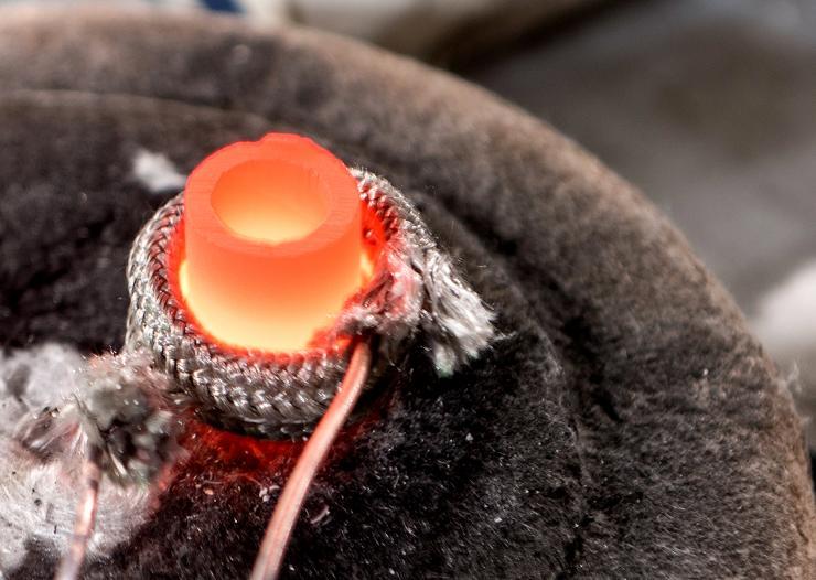 <p>Researchers have developed a new low-cost technique for converting bulk powders directly to oxide nanowires. Shown is a crucible in which an alloy of lithium and aluminum is being formed. (Credit: Rob Felt, Georgia Tech)</p>