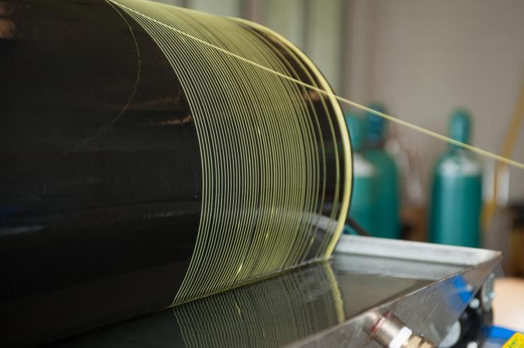 <p>Photo shows the manufacture of polymer hollow fiber membranes, which are precursors to more advanced carbon molecular sieve hollow fiber membranes. (Credit: Rob Felt, Georgia Tech)</p>